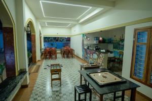 a room with a table and chairs and a dining room at Swastha Royals Wayanad in Kaniyāmbetta