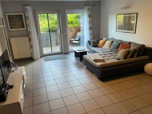 a living room with a couch and a table at Apartment Akazie in Weinsheim