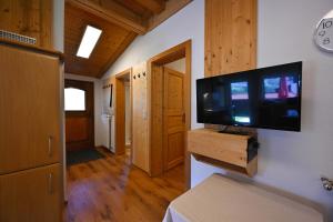 a living room with a flat screen tv on a wall at Appartements Oberdorfer in Landeck