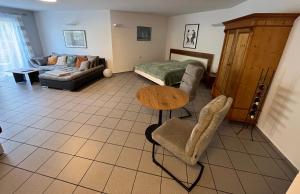 a living room with a couch and a table at Apartment Akazie in Weinsheim
