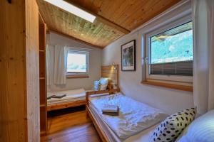 a small room with a bed and a window at Appartements Oberdorfer in Landeck