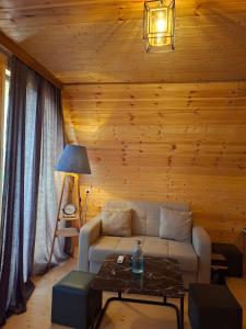 a living room with a couch and a table at WILD NEST Cottage 