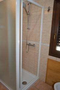 a shower with a glass door in a bathroom at il nido in Capoterra