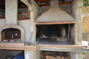 a large brick oven with a fire in it at il nido in Capoterra +1 photo