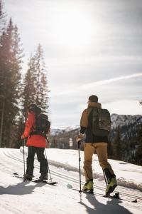 two people standing on skis in the snow at Hotel Tofana in San Cassiano +18 photos