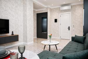 a living room with a couch and a table at Delmar Boutique Buzovna in Mekhrably