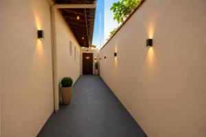 a corridor of an office building with lights on the walls at Pousada Jeitim Mineiro in Capitólio