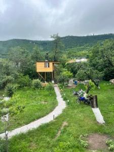 a house on a hill with a path leading to it at Tree House & Camping Goris in Goris