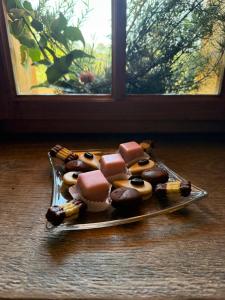 a plate of chocolate covered donuts on a table at Kellerstöckl Hütter in Güssing +23 photos