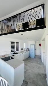 a kitchen with white cabinets and a blue refrigerator at Regina Maris in Betina