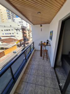 a balcony with a table and a view of a city at Apartamento 3 Quartos, Churrasqueira, Vista Mar, Varanda, 5 min da praia in Guarapari +10 photos