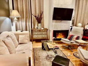 a living room with a couch and a fireplace at LOFT & SPA PRIVATIF in Dijon