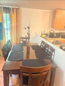 a dining room table with chairs and a kitchen at Peace in Lake Hartwell in Hartwell +9 photos