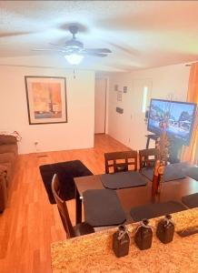 a living room with a dining room table and a television at Peace in Lake Hartwell in Hartwell