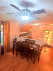 a dining room with a table and a ceiling fan at Peace in Lake Hartwell in Hartwell