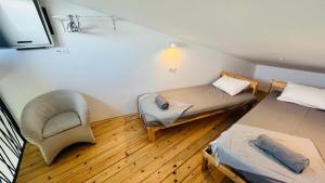 a small room with two beds and a chair at Regina Maris in Betina +32 photos