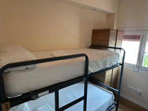 two bunk beds in a room with a window at Can Cocollona in Girona +98 photos