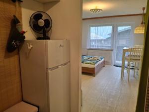 a kitchen with a refrigerator and a dining room at Ferienwohnung 6 Bergblick in Sankt Gilgen