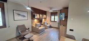 a living room with a chair and a couch at Apartamentos Saila in Castejón de Sos