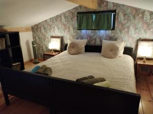 a bedroom with a large bed with two lamps at Le Cigalou - Drôme Provencale in Sainte-Jalle +21 photos