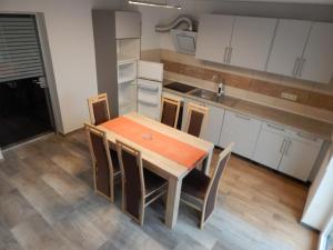 a kitchen with a wooden table and chairs in it at Landhaus Klein Markow in Jördenstorf +22 photos