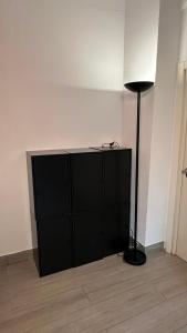 a black cabinet with a black lamp in a room at Can Cocollona in Girona