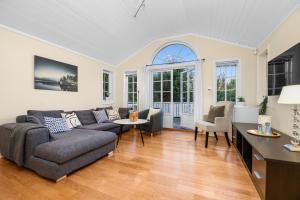 a living room with a couch and a table at Cozy apartment in South of Norway! in Svenevik