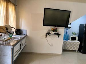 a kitchen with a flat screen tv on the wall at Vista colonial suite in Comayagua