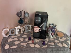 a coffee maker sitting on a table with a coffee mug at A casa di Lea2 in Gioia dei Marsi