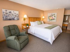 a bedroom with a large bed and a chair at Alleghany Inn Blue Ridge in Sparta +32 photos