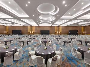 a large banquet hall with tables and chairs at Pullman Jakarta Central Park in Jakarta +146 photos