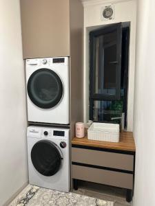 a laundry room with two washer and dryer at Teskey Hostel Karakol in Karakol