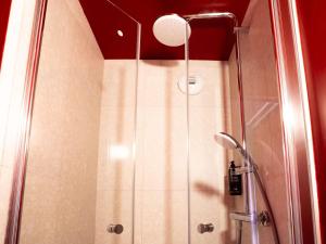 a shower with a glass door in a bathroom at ibis Styles Bourg-en-Bresse Centre in Bourg-en-Bresse +16 photos