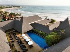 an aerial view of a resort with a swimming pool and the beach at The Kuta Beach Heritage Hotel - Managed by Accor in Kuta