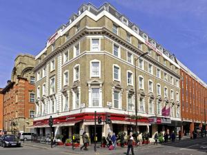 a large building on the corner of a street at Mercure London Paddington Hotel in London
