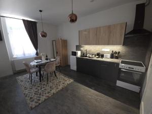 a kitchen with a table and a stove top oven at Happyzem in Sátoraljaújhely