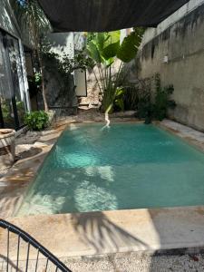 a swimming pool with blue water in a backyard at Casa Ramon Merida 2 BR AC Private Pool Centro in Mérida