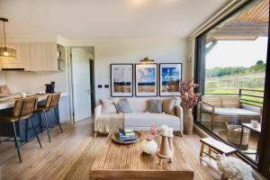 a living room with a couch and a table at Private Terrace with Wellness Studio & Fireplace in Puerto Varas