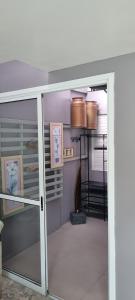a sliding glass door in a room with a kitchen at Cantinho das Orquídeas! in Pelotas