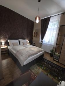 a bedroom with a large bed and a window at Happyzem in Sátoraljaújhely