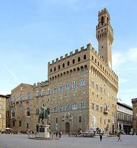 a large building with a clock tower and a statue at Sea Horse in Lido di Camaiore +20 photos