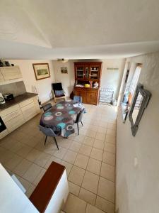 a living room with a table and a kitchen at Mélodies d'Alsace in Lipsheim +11 photos