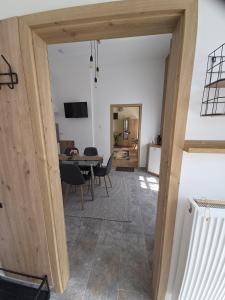 a view of a living room with a table and chairs at Happyzem in Sátoraljaújhely