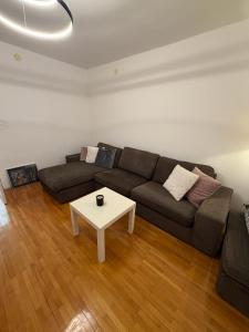 a living room with a couch and a table at DiSte Apartman in Knin