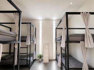 a room with four bunk beds in it at Wavez Lombok Hostel in Selong Belanak