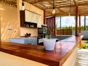 a kitchen with a wooden counter top in a room at Wavez Lombok Hostel in Selong Belanak