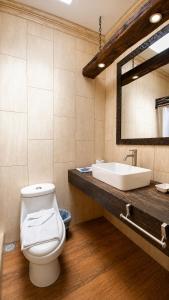 a bathroom with a toilet and a sink at Casa Mia Hotel in Antigua Guatemala +93 photos