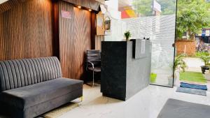 a lobby with a couch and a chair in a room at Hotel cressida green palace - near redisson squar in Indore