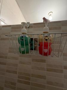 a rack with three different colored toilets in a bathroom at Appartement entier accès rapide Paris et parc dexpo in Sevran