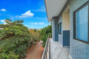 a balcony with a view of a house at Hotel O DLF Phase 1 Metro Station Gurugram in Gurgaon +39 photos